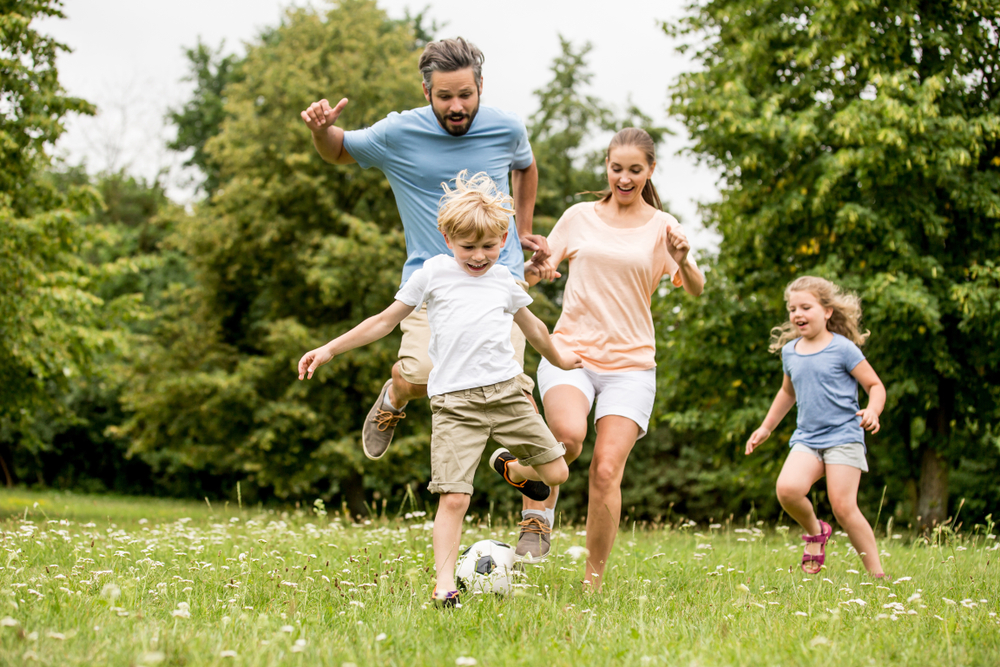 family enjoying playtime soccer outside in Grayson, GA ©Robert Kneschke