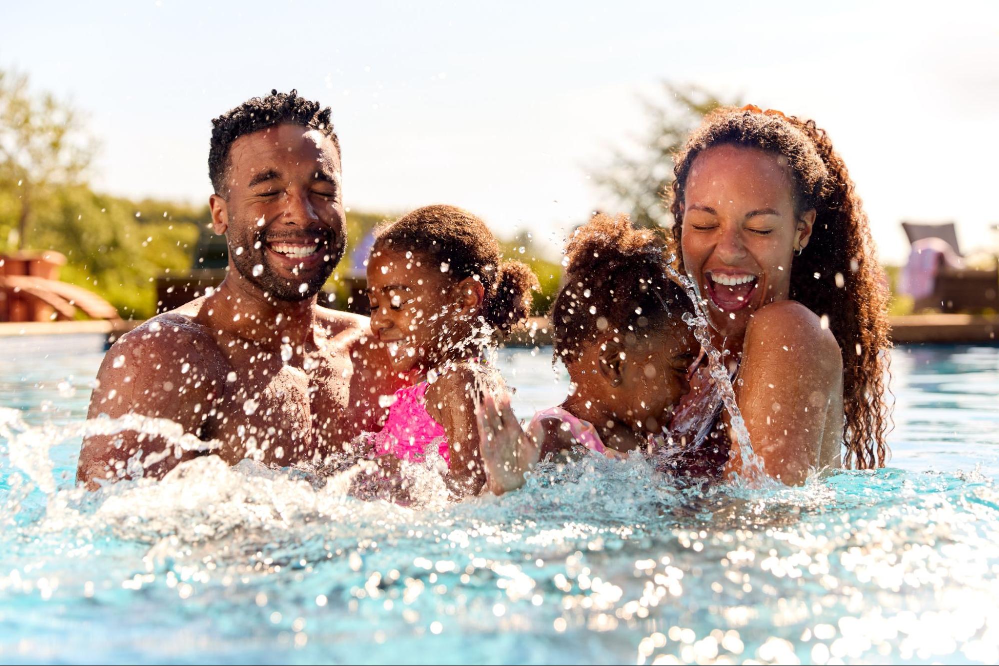 family swimming at a pool in summer ©Monkey Business Images