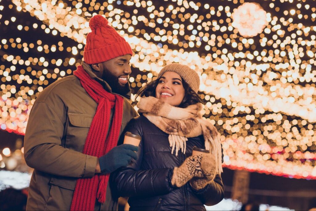 Couple Walking Under Lights during Winter ©Roman Samborskyi