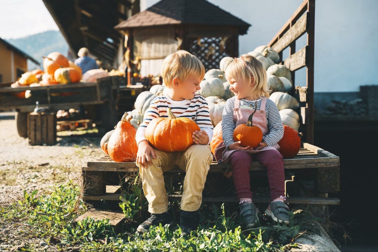 Children on the back of truck with pumpkins ©Natalia Deriabina