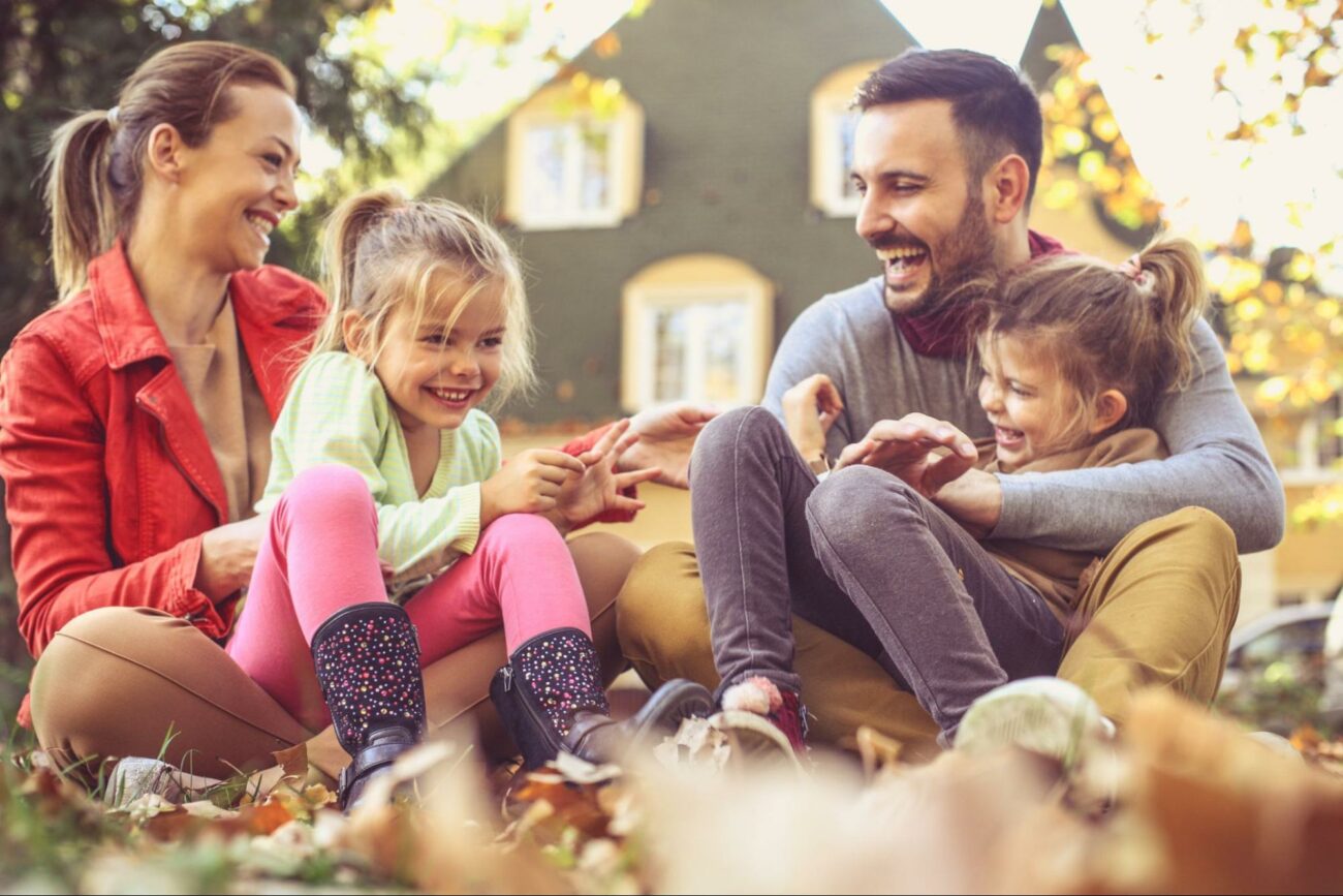 Family playing in the fall leaves ©