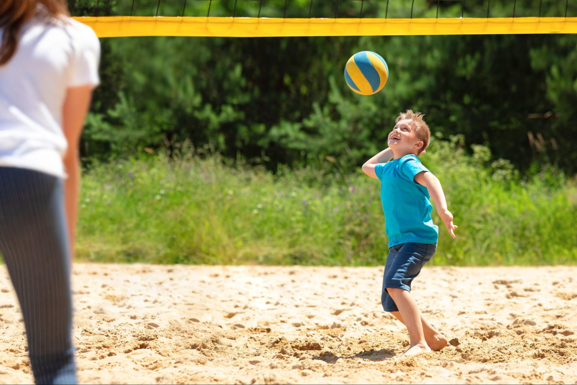 Kid playing sand volleyball
©Here